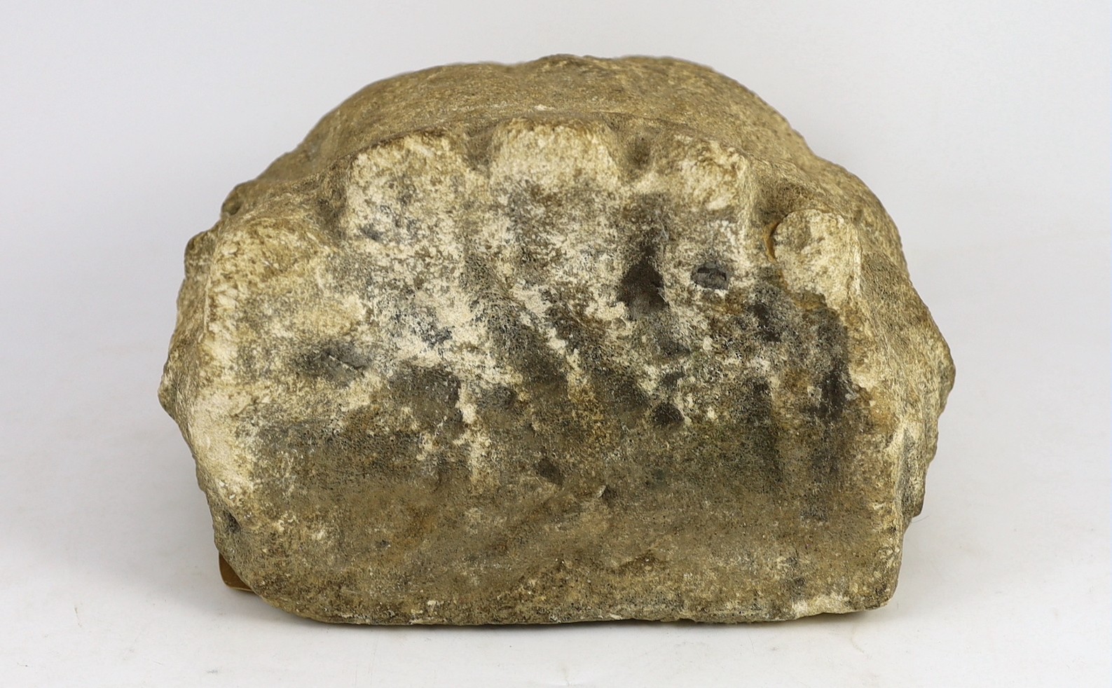 An English carved limestone head of a bearded king, possibly Anglo-Saxon, 25cm high 22.5cm wide